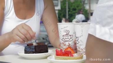 男人和女人吃着巧克力和草莓甜点，喝着咖啡，吃着美味的蛋糕